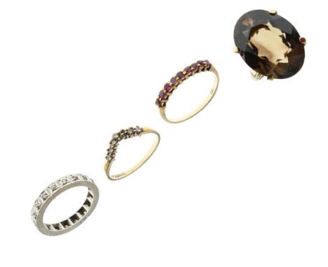 Three 9ct gold dress rings comprising: diamond wishbone ring, nine-stone ruby ring, and another, together with a white metal 