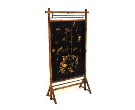 Early 20th Century bamboo framed firescreen having needlework panel of floral design against a black ground, 62cm high  