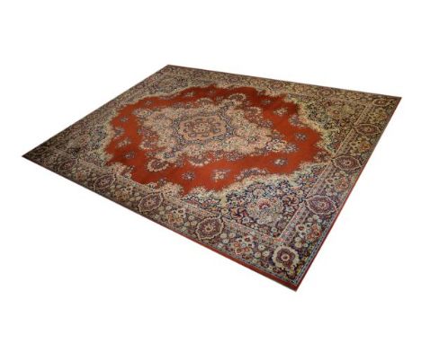 Large Axminster-style machine-made carpet, the red ground with floral and foliate scroll decoration, 394cm x 297cm  