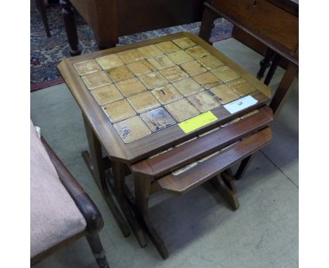 A Danish design teak nest of three tables with tile insets 