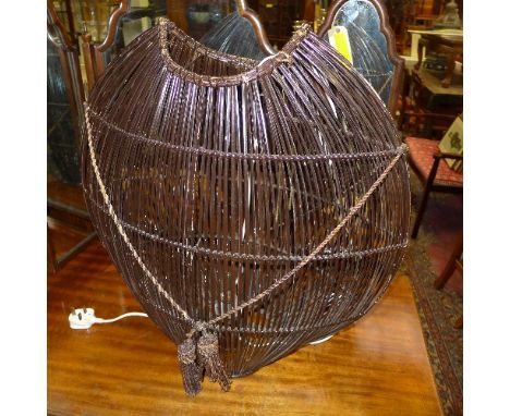 A contemporary ovoid form basket weave lamp