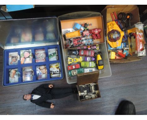 A shelf of diecasts including Corgi, Matchbox & Britains etc, James Bond doll and spy card set, dominoes etc