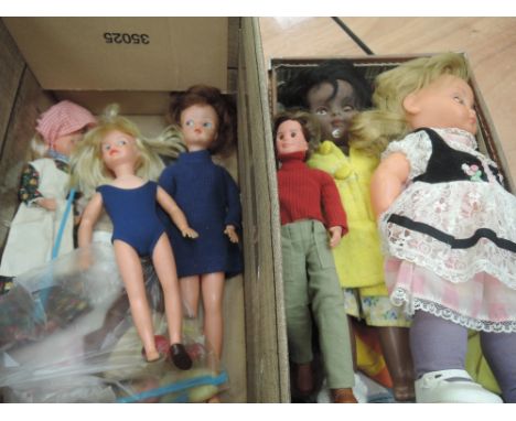 A small box and suitcase containing mid 20th century and later hard plastic dolls including Bella, Mattel etc and a selection