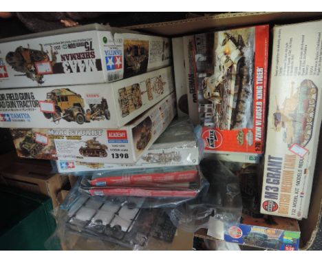 A box of Airfix, Tamiya and similar plastic mixed scale kits including Sherman tank, M3 Great British medium tank and similar