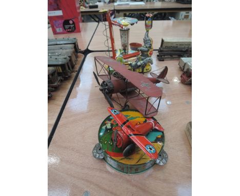 Five 1960's and later tin plate toys including Marx aeroplane, West German circus elephant etc and a similar German single se
