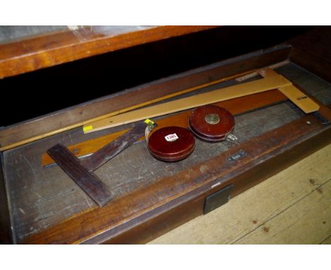 A Victorian yard stick,&nbsp;inscribed 'LCC'; together with two leather cased tape measures; and three others.&nbsp; 