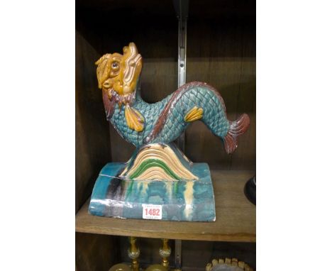 A Chinese sancai glazed roof ridge tile,&nbsp;surmounted by a dolphin, 28cm high, (repaired). 