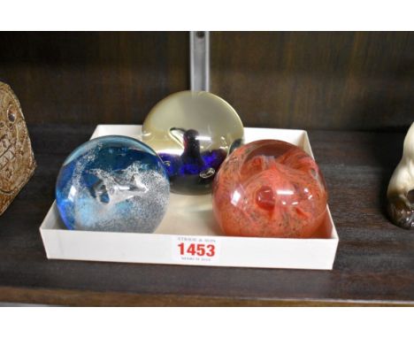 Three Caithness glass paperweights. 