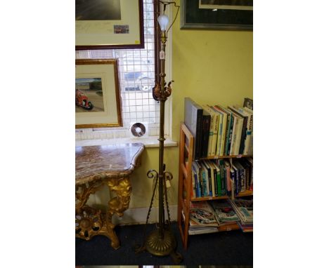 An Arts &amp; Crafts style brass adjustable tripod standard lamp. 