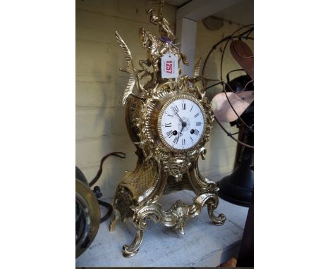 A brass mantel clock,&nbsp;46cm high, with pendulum. 