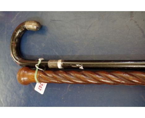 A silver mounted walking stick;&nbsp;together with an oak spiral reeded cane. 