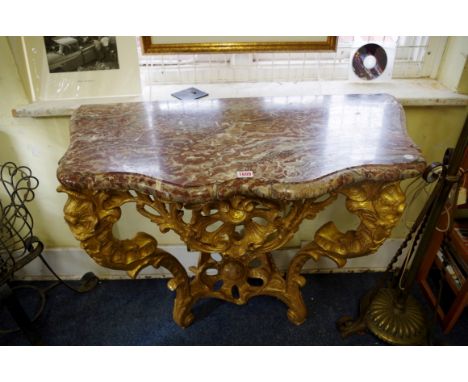 An antique carved giltwood and marble top console table,&nbsp;of shaped outline, 97cm wide.&nbsp; 