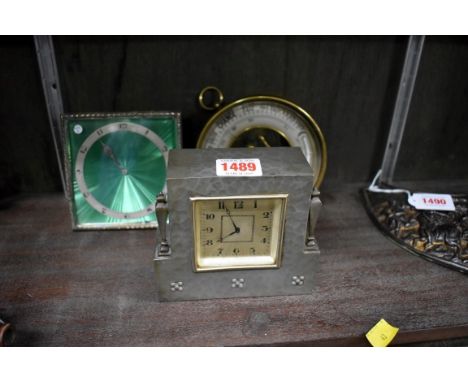 An Art Deco electroplated easel back timepiece,&nbsp;11.5cm wide; together with another pewter timepiece; and a brass aneroid