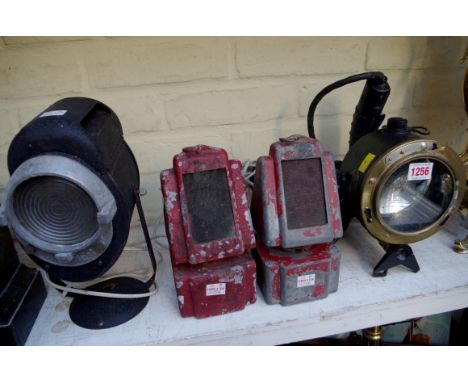 Four various vintage lamps, comprising two old red painted railway lamps, 21cm high; a Cremer theatre lamp, 26cm high; and an