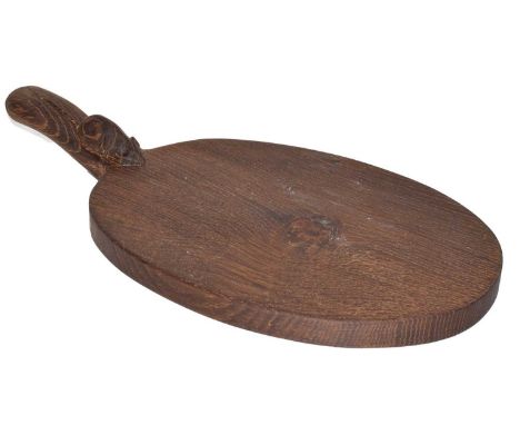 Workshop of Robert Mouseman Thompson, English oak cheeseboard, dark fume with carved mouse trademark on handle, 39cm long