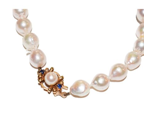A cultured pearl necklace knotted to a 9 carat gold cultured pearl and sapphire clasp, length 69cm