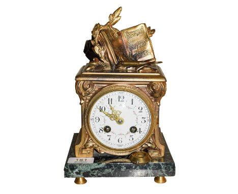 A nineteenth century French gilt metal striking mantle clock with enamel dial and raised on a marble plinth striking half hou