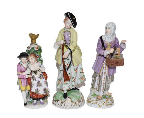 An early 20th century Meissen figures modelled as a lady with a small animal, a Dresden figure of a lady hunting, and a Sitze