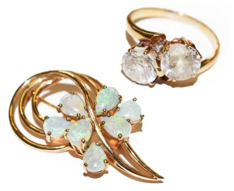 An opal brooch, stamped '10CT', length 4cm; and an unmarked gem set ring, finger size OCondition report: Brooch - 6.4 grams. 