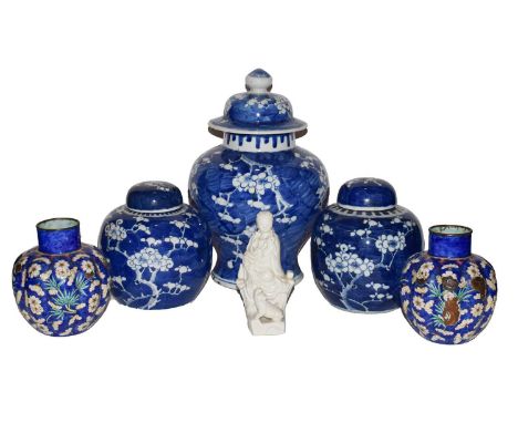A 19th century Chinese Kangxi style blue and white ginger jar and cover painted with prunus blossom; together with a similar 