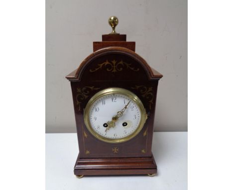 An Edwardian inlaid mahogany bracket clock with enamel dial, brass feet and finial 