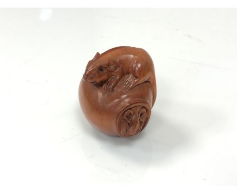 A carved Chinese hardwood netsuke - Two rats on a pot