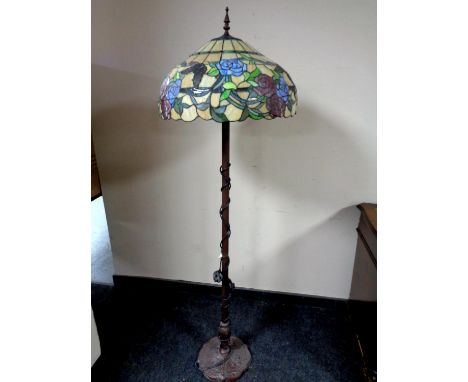 A Tiffany style standard lamp with leaded glass shade  