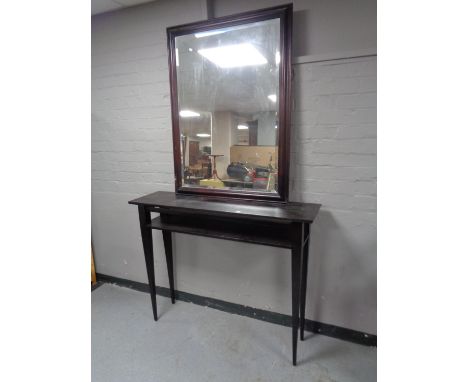 A contemporary console table together with bevelled overmantel mirror and two table lamps 