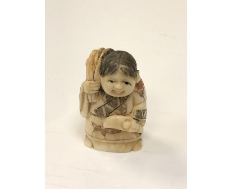 A carved Chinese bone netsuke - Elderly woman carrying a sack