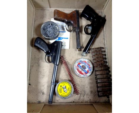 A box of Gat air pistol, Milbro Mod 2 air pistol together with one other (a/f), a Daisy air pistol operation manual, tins of 