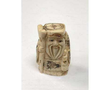 A carved Chinese bone netsuke - Village elder with staff 