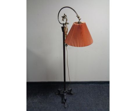 An early 20th century brass floor lamp on cast iron base 
