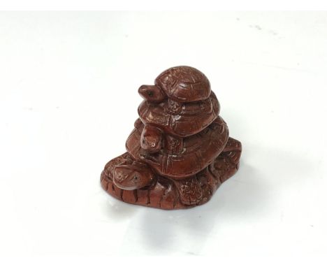 A carved Chinese hardwood netsuke - turtle family 