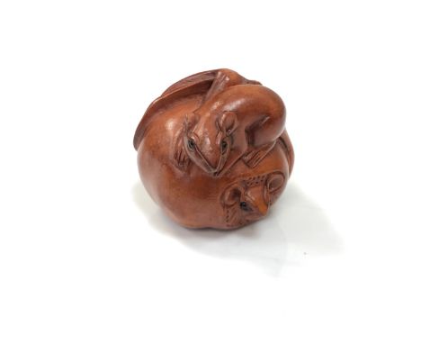 A carved Chinese hardwood netsuke - Rats eating a fruit