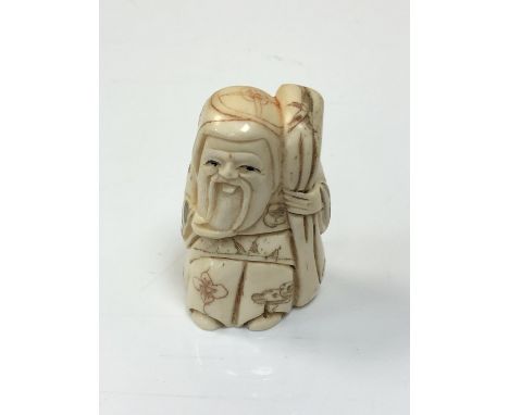 A carved Chinese bone netsuke - village elder with staff 