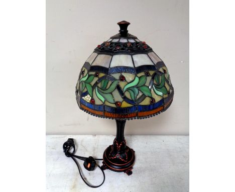 A Tiffany style table lamp with leaded glass shade  