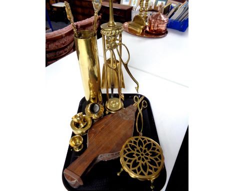 A tray of brass ammunition shell, companion set and pieces, trivet, jug etc together with a set of bellows 