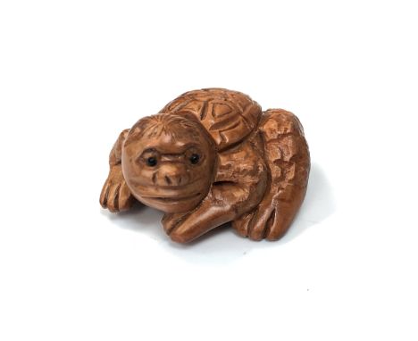 A carved Chinese hardwood netsuke - Mythical creature 