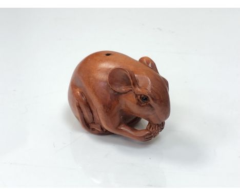 A carved Chinese hardwood netsuke - rat feeding