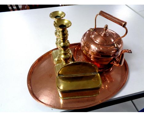 An oval copper serving tray together with a further copper embossed tray, a copper teapot and a pair of brass candlesticks 