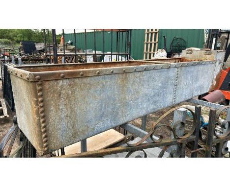 A GALVANISED AND RIVETED FARM TROUGH, 54CM (H) X 244CM (L) X 44CM (D) / ALL LOTS ARE LOCATED IN SL0 9LG, REGRETFULLY WE DO NO