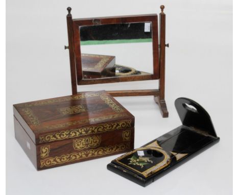 An Edwardian rosewood, cut brass inlaid sewing box, A Victorian papier-m&acirc;ch&eacute; book slide and a small toilet mirro