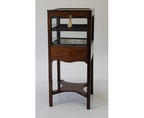 A George III mahogany night stand, converted as a bijouterie cabinet, with hinged glazed top and sides enclosing two plush li