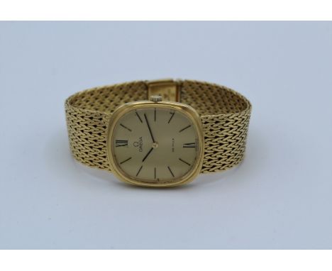 A 1970's Omega De Ville 18 carat gold wristwatch, the matching dial having Roman and baton numerals and a fine mesh link band