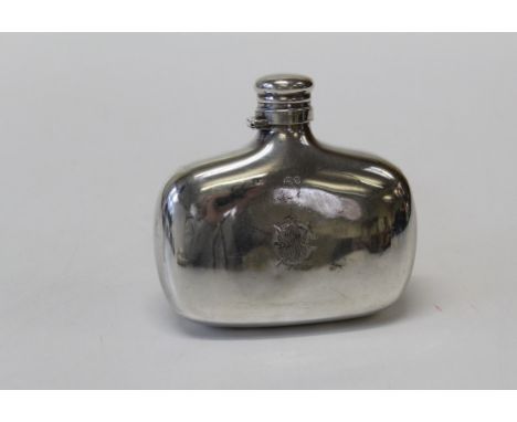 A Victorian silver hip flask with bayonet cap and engraved crest, London 1882