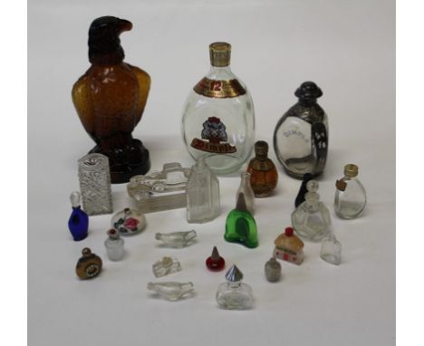 A silver overlaid Dimple Scotch Whisky bottle, 17cm together with a miniature sealed Dimple Whisky, an amber glass eagle deca