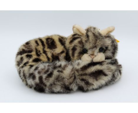 A curled up Steiff cat, Steiff tag to ear, number 074189