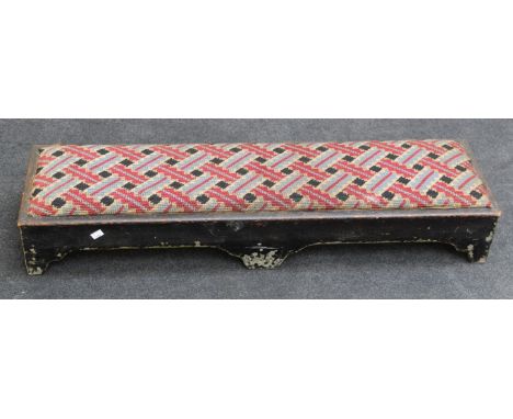 An early 19th century pine long footstool with later upholstered drop in pad, on bracket feet, 112cm