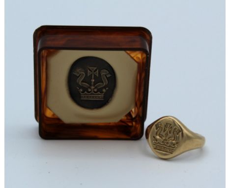 A 9ct gold clerical seal ring, with an engraving of a coronet, tippet and cross, size J. Together with a ceramic seal impress