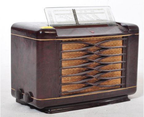 A retro vintage mid 20th Century Philips valve radio. With its radio display on top with knobs and embroidered material front